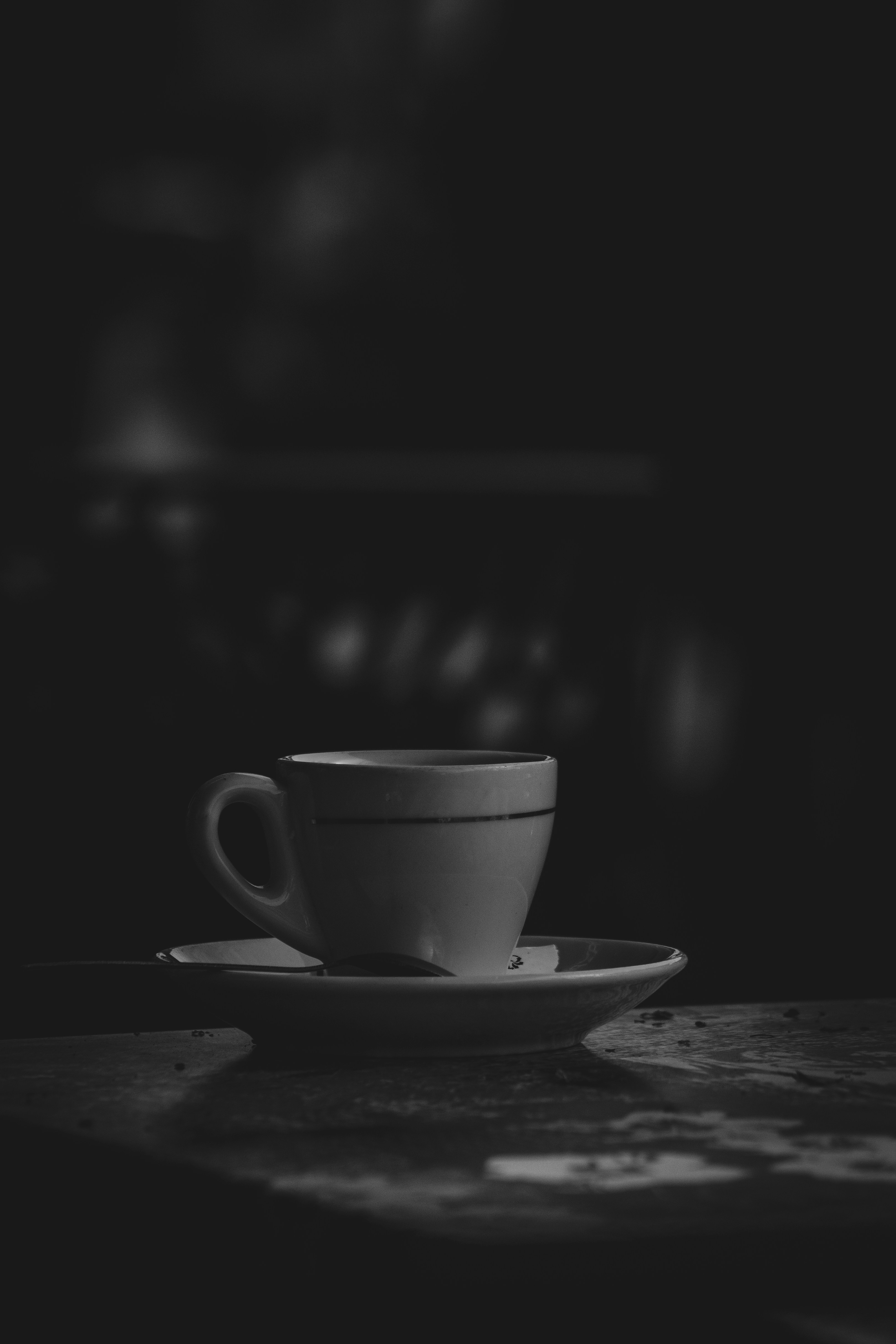 A cup of specialty coffee in dim, warm light